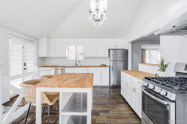a kitchen with white cabinets sink and white appliances