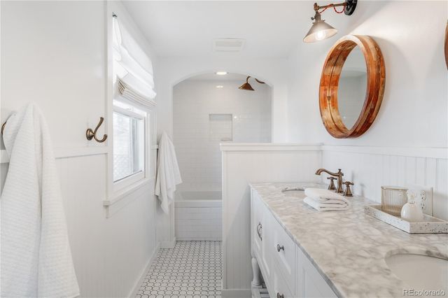 a bathroom with a granite countertop sink and mirror