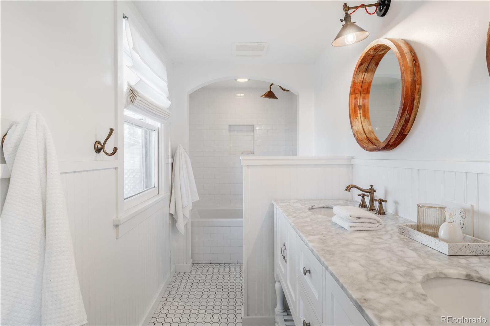 3940 Quay Street Wheat Ridge, CO 80033 - Photo 21 of 28 a bathroom with a sink and a mirror