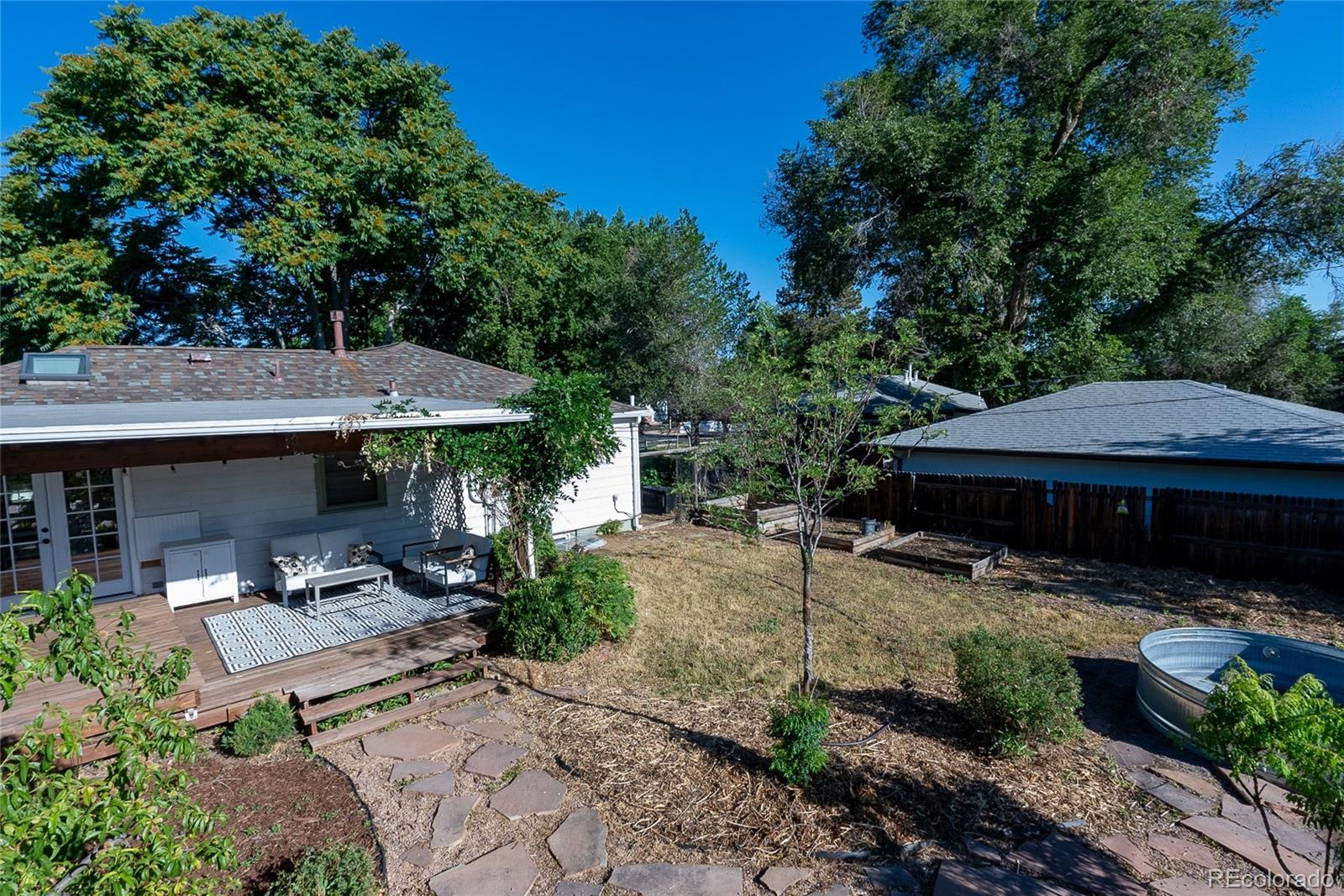 3940 Quay Street Wheat Ridge, CO 80033 - Photo 28 of 28 a view of a patio with table and chairs under an umbrella