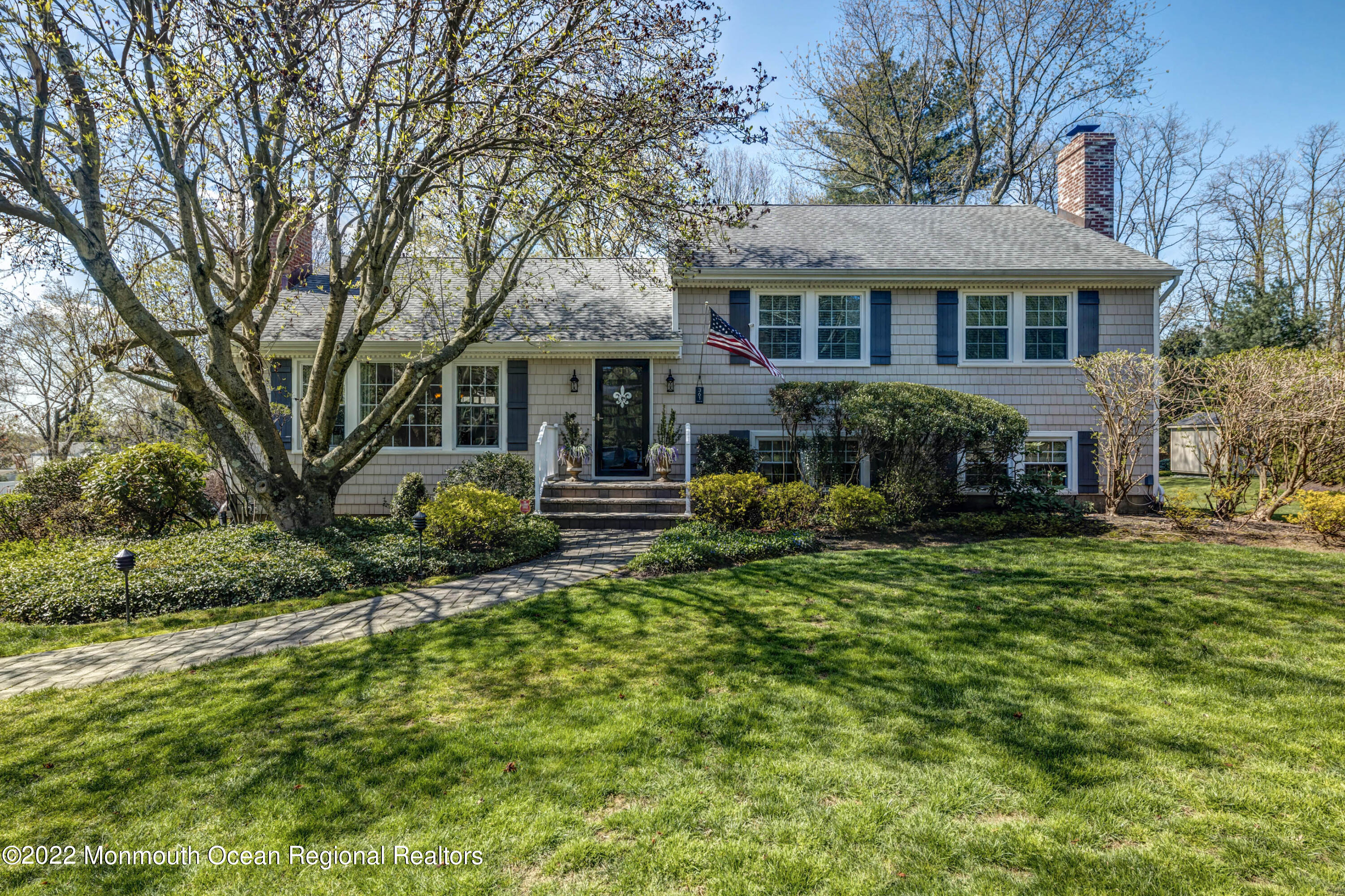 361 Dwight Road Middletown, NJ 07748 - Photo 1 of 39 a front view of a house with a yard table and chairs