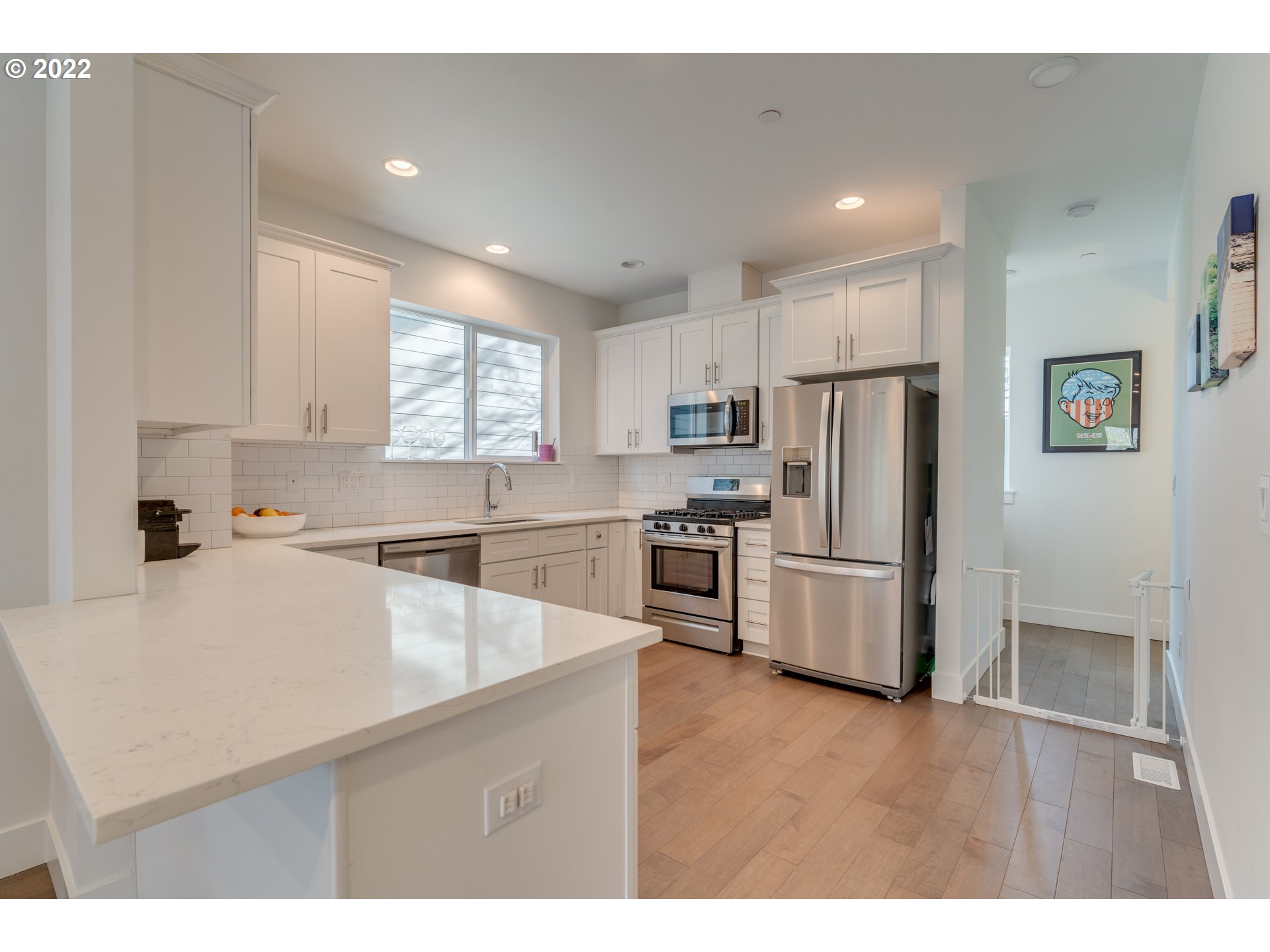 4209 Southeast 80th Avenue Portland, OR 97206 - Photo 11 of 32 a kitchen with white cabinets and stainless steel appliances