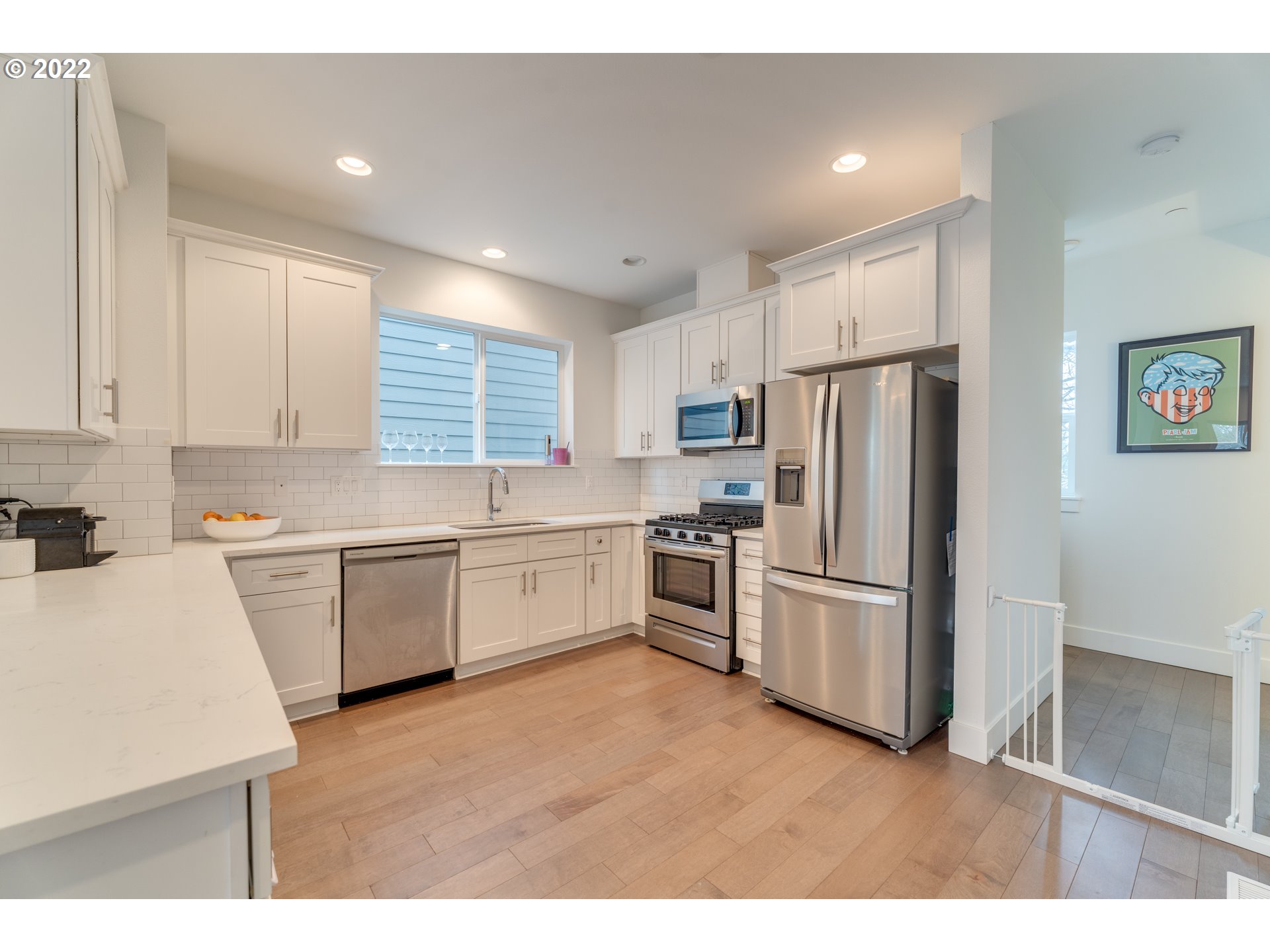 4209 Southeast 80th Avenue Portland, OR 97206 - Photo 14 of 32 a kitchen with white cabinets and stainless steel appliances