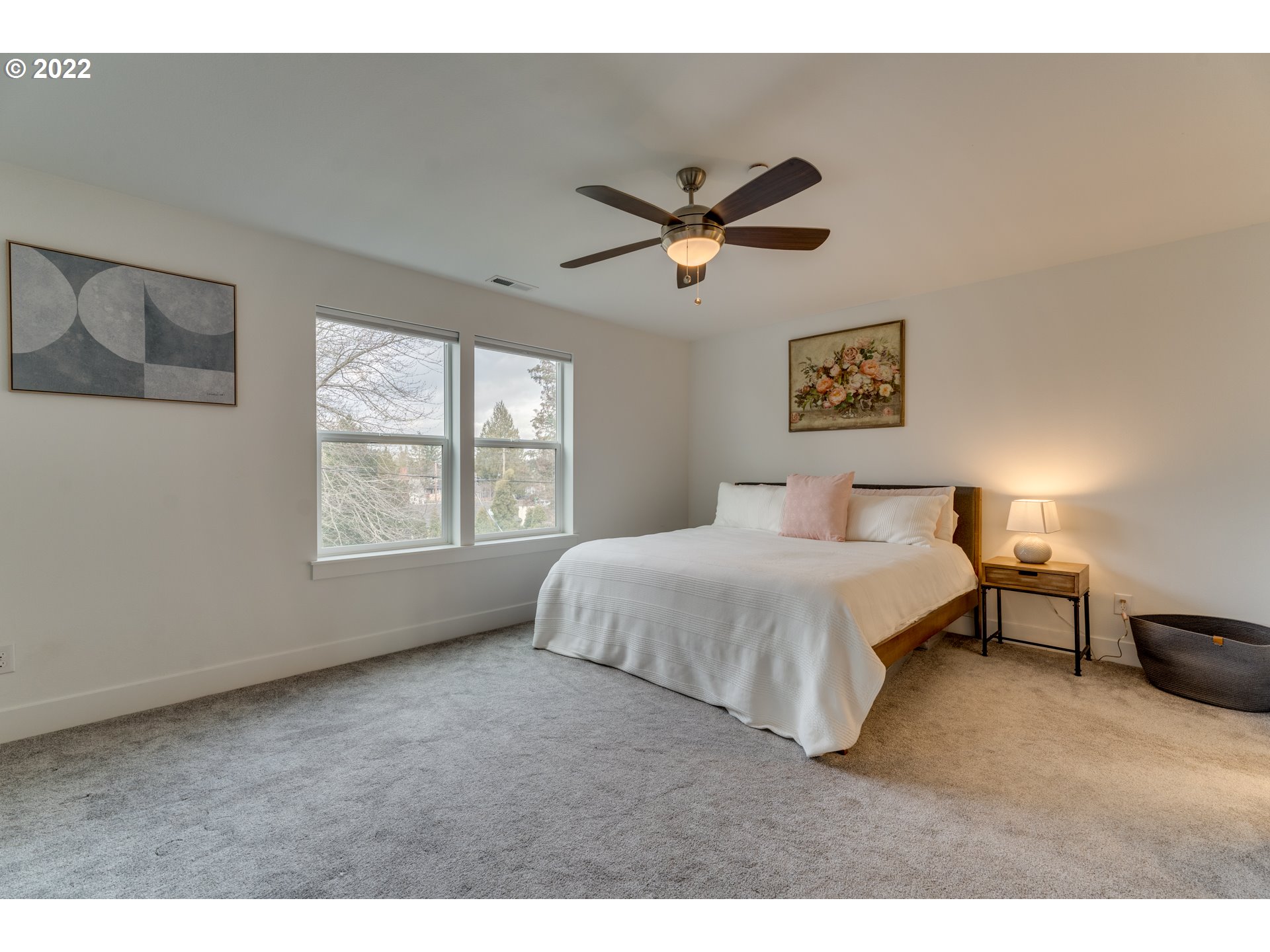 4209 Southeast 80th Avenue Portland, OR 97206 - Photo 18 of 32 a spacious bedroom with a bed a window and a chandelier