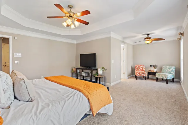 a bedroom with a bed and a chandelier