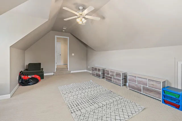 a living room with furniture and large windows