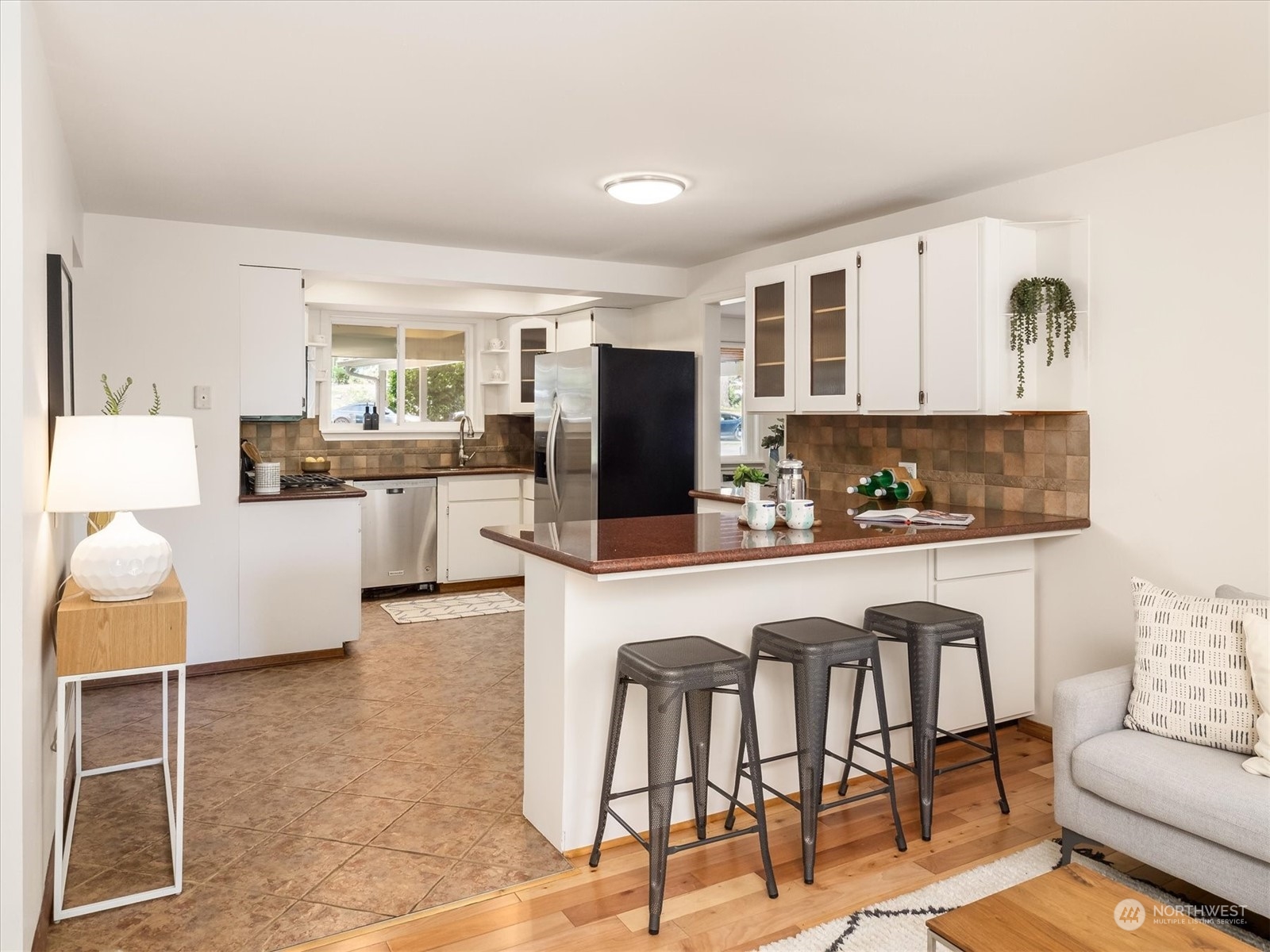 1126 203rd Place Southeast Bothell, WA 98012 - Photo 7 of 26 a kitchen with stainless steel appliances kitchen island granite countertop a table and chairs