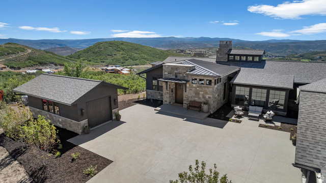 2192 East Outlaw Road Kamas, UT 84036 - Photo 34 of 80 Expansive driveway with stone and dark-toned siding on the main residence and detached garage