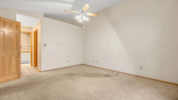 a view of a room with a ceiling fan and a window