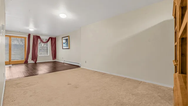 an empty room with a window and a projector