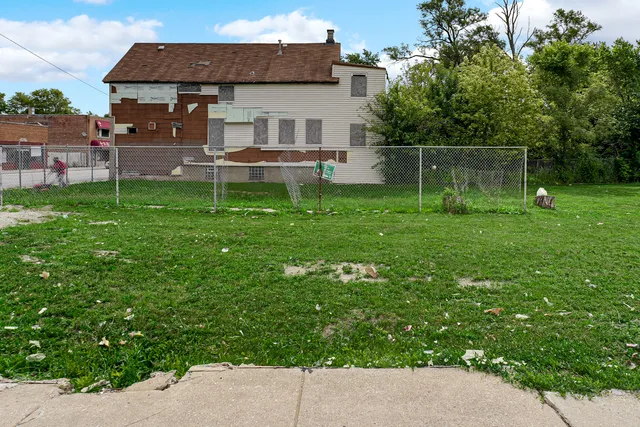 a backyard of a house with table and chairs