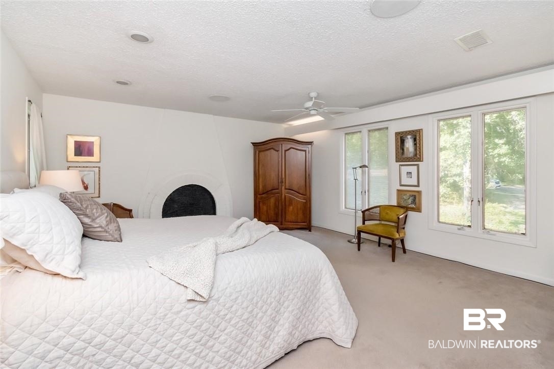 305 Fern Hill Court Mobile, AL 36608 - Photo 22 of 53 Carpeted bedroom featuring ceiling fan and a textured ceiling