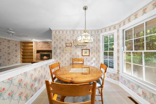 a dining room with furniture a chandelier and window