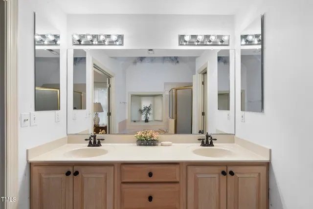 a bathroom with a sink double vanity and a mirror
