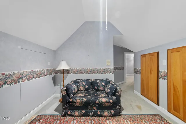 a view of a bedroom with wooden floor and windows
