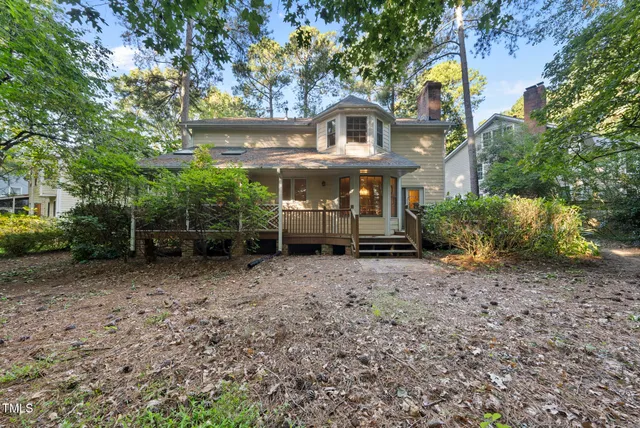 a view of a house with a yard and hanging chair