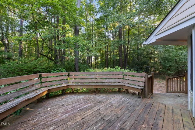 a view of a wooden bench sitting in the backyard