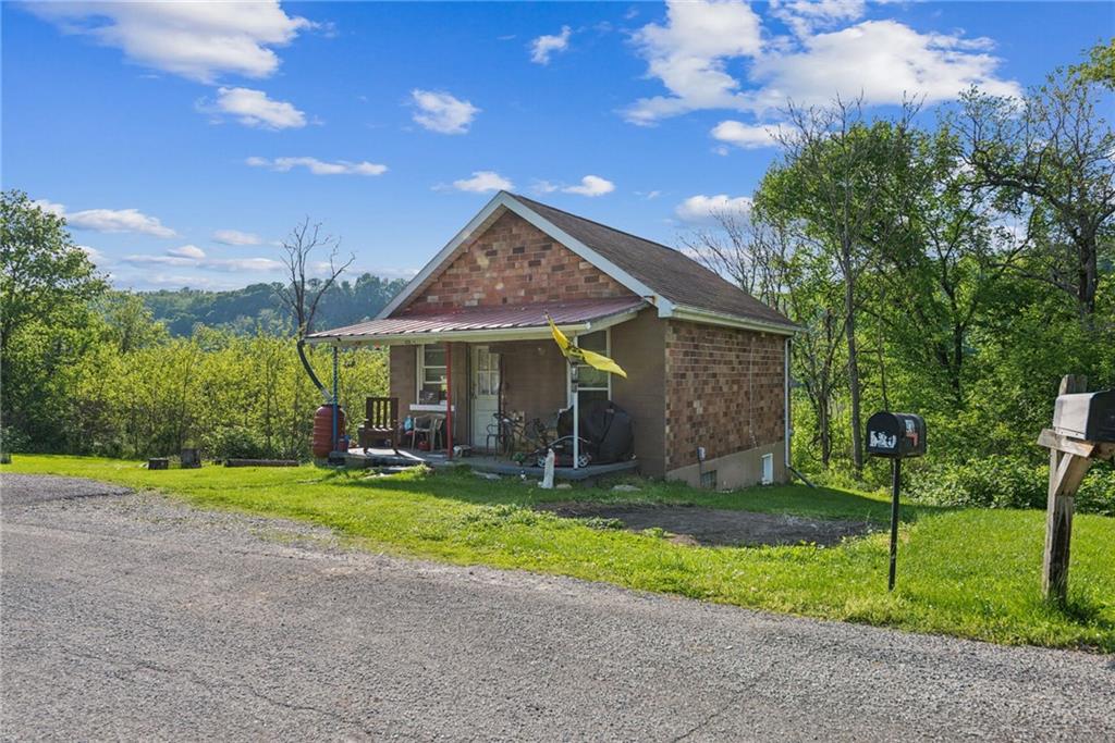 375 Reduction Road Smithton, PA 15479 - Photo 22 of 30 a front view of a house with garden and porch