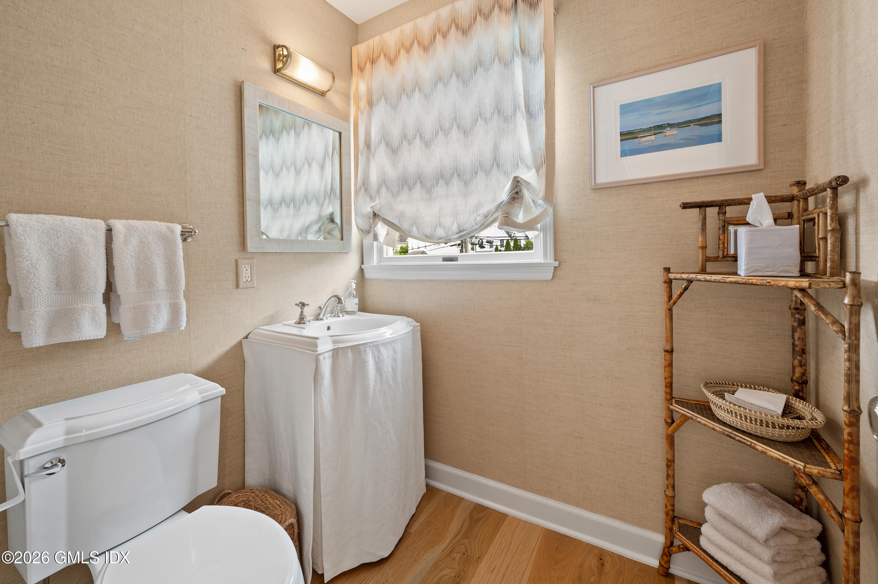 115 River Road, Unit 3 Cos Cob, CT 06807 - Photo 18 of 40 a bathroom with a toilet a sink and a mirror