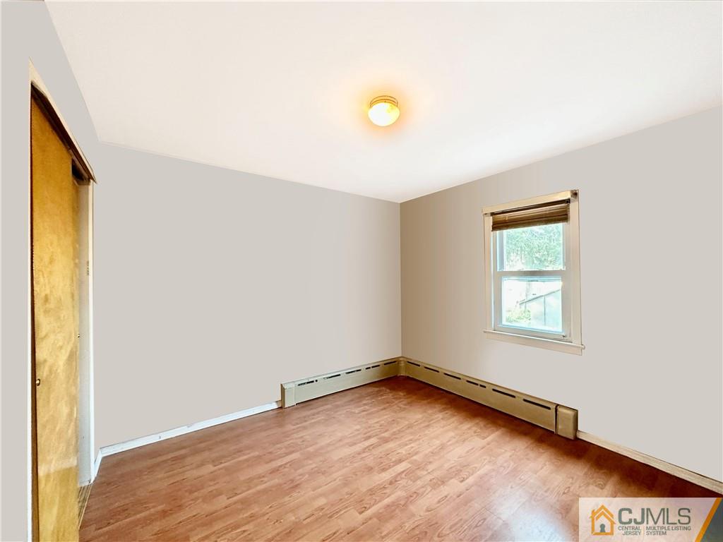 8 Spring Street South River, NJ 08882 - Photo 6 of 8 an empty room with wooden floor and windows
