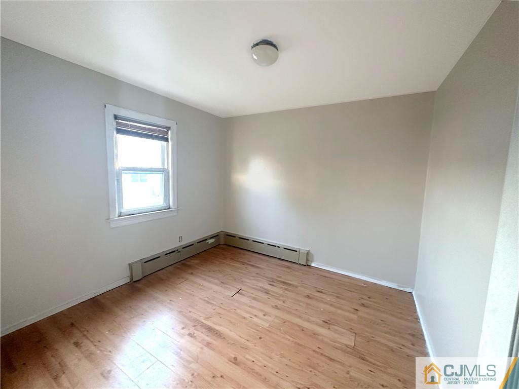 8 Spring Street South River, NJ 08882 - Photo 7 of 8 an empty room with wooden floor and windows