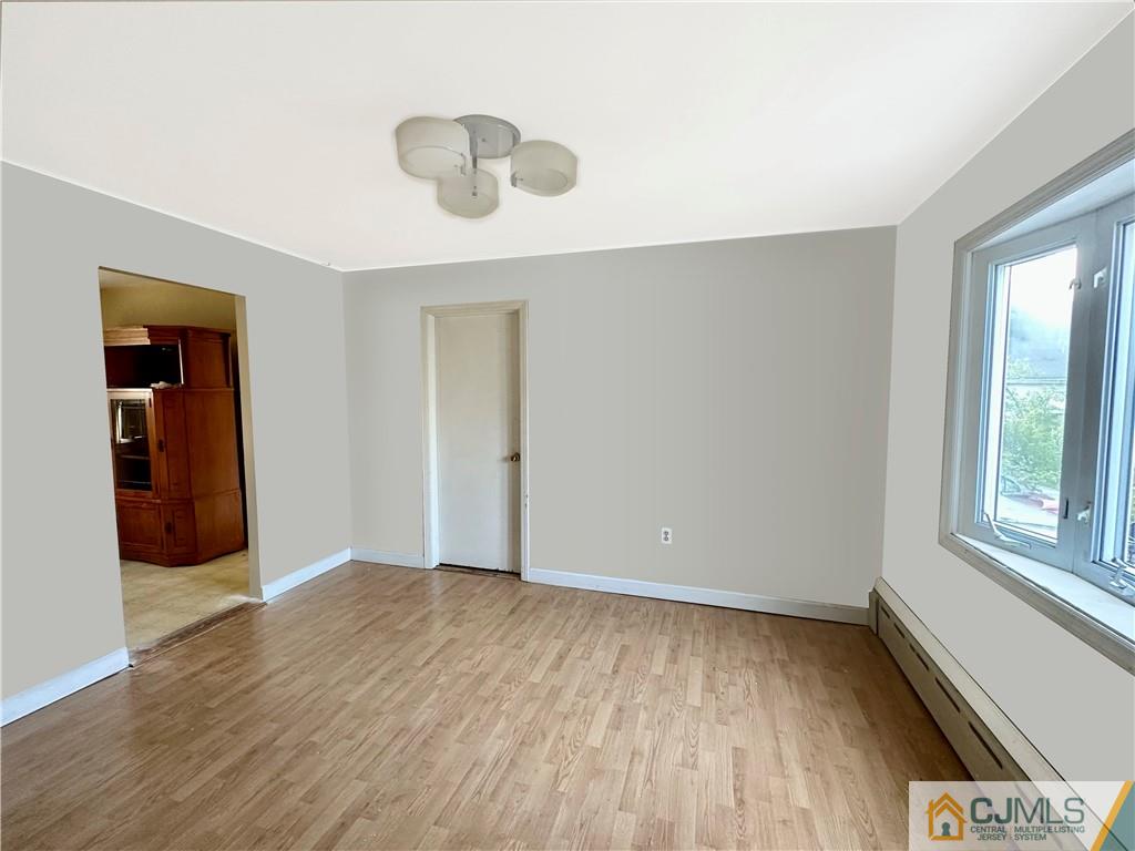8 Spring Street South River, NJ 08882 - Photo 8 of 8 an empty room with wooden floor and windows