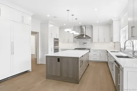 a kitchen with stainless steel appliances kitchen island a sink stove and refrigerator