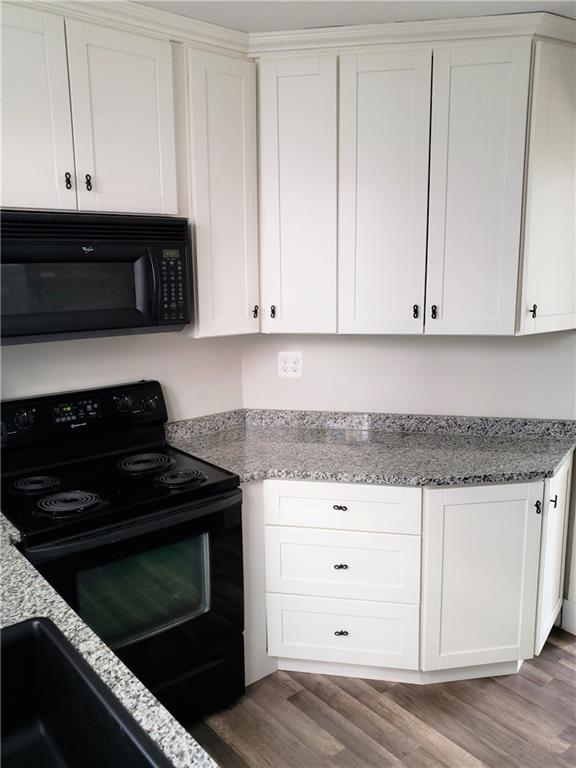 201 Richbarn Road Pittsburgh, PA 15212 - Photo 12 of 24 a kitchen with granite countertop white cabinets and black appliances