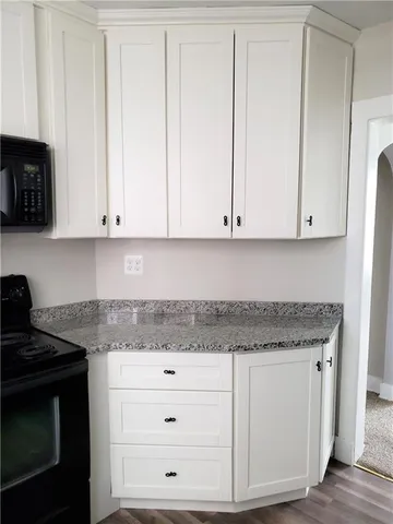 a kitchen with stainless steel appliances granite countertop a sink stove and microwave