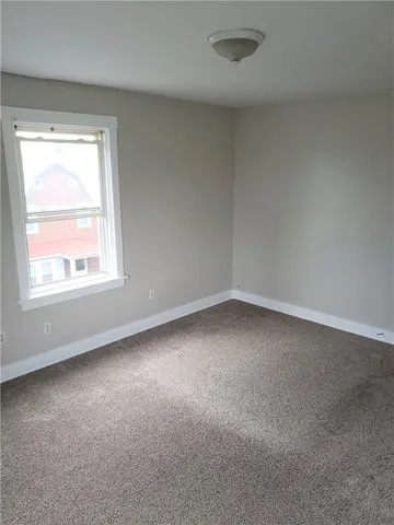 a view of an empty room with closet