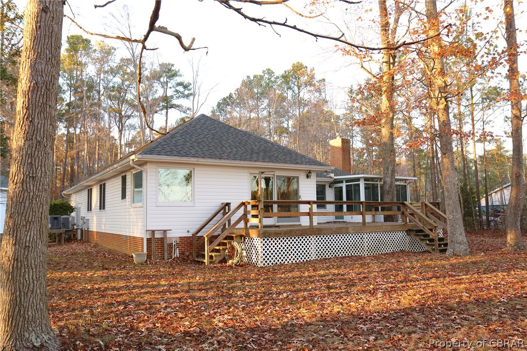 97 Barnes View Lane Kilmarnock, VA 22482 - Photo 4 of 20 Water side of the home with deck and sun room.