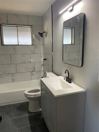 a bathroom with a sink a toilet and bathtub