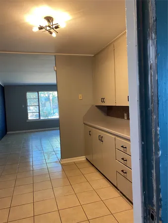 a view of a kitchen with a dishwasher and a stove top oven