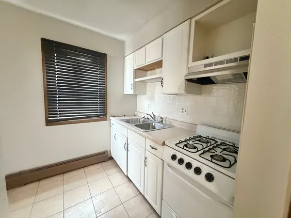 a kitchen with cabinets and a stove top oven