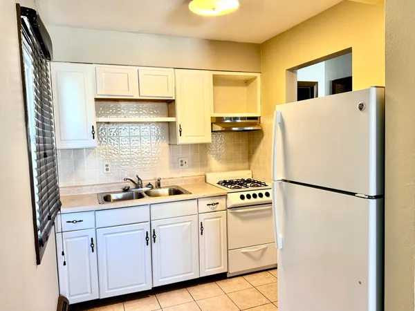 a kitchen with stainless steel appliances a refrigerator sink and cabinets