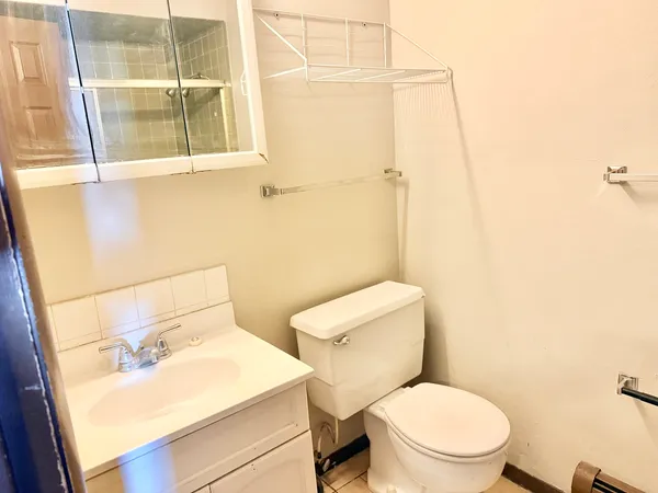 a white toilet sitting next to a bathroom sink