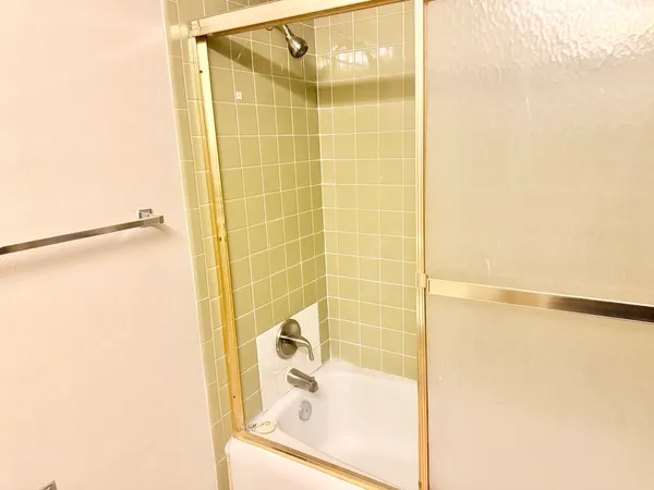 a bathroom with a shower and a sink