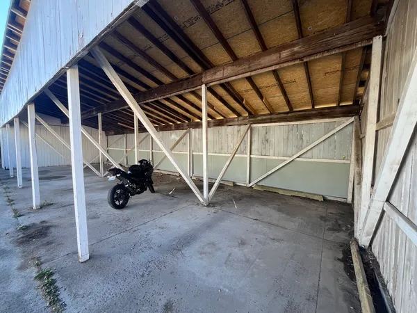 a view of an empty room with wooden walls