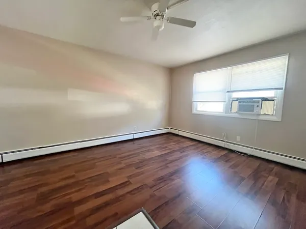 wooden floor in an empty room with a window