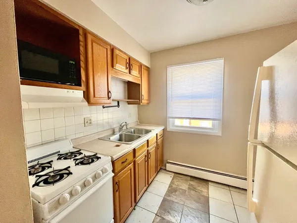 a kitchen with a sink stove and microwave