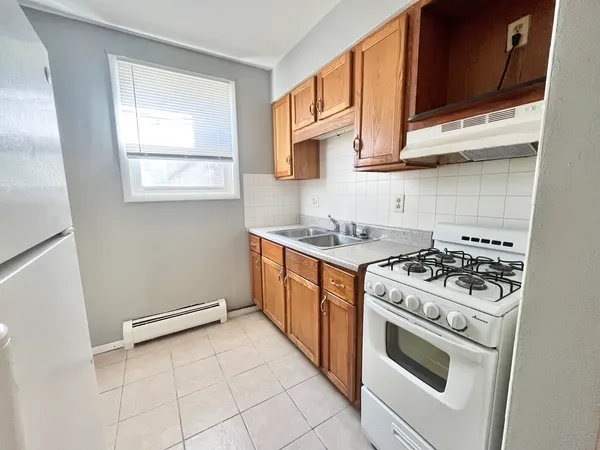 a kitchen with stainless steel appliances a stove a microwave and cabinets