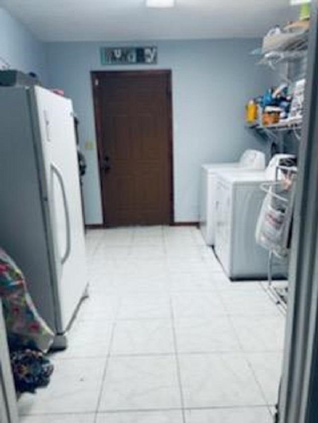 3121 Green Acres Road St. Augustine, FL 32084 - Photo 17 of 35 a utility room with fridge and washer