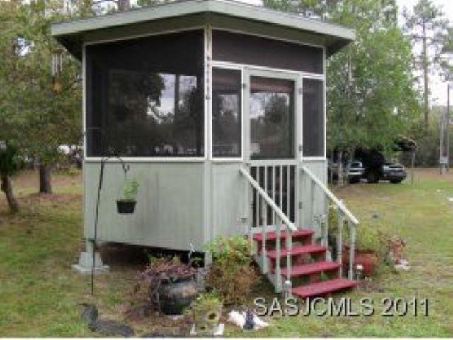 3121 Green Acres Road St. Augustine, FL 32084 - Photo 24 of 35 a view of a house with a yard and sitting area