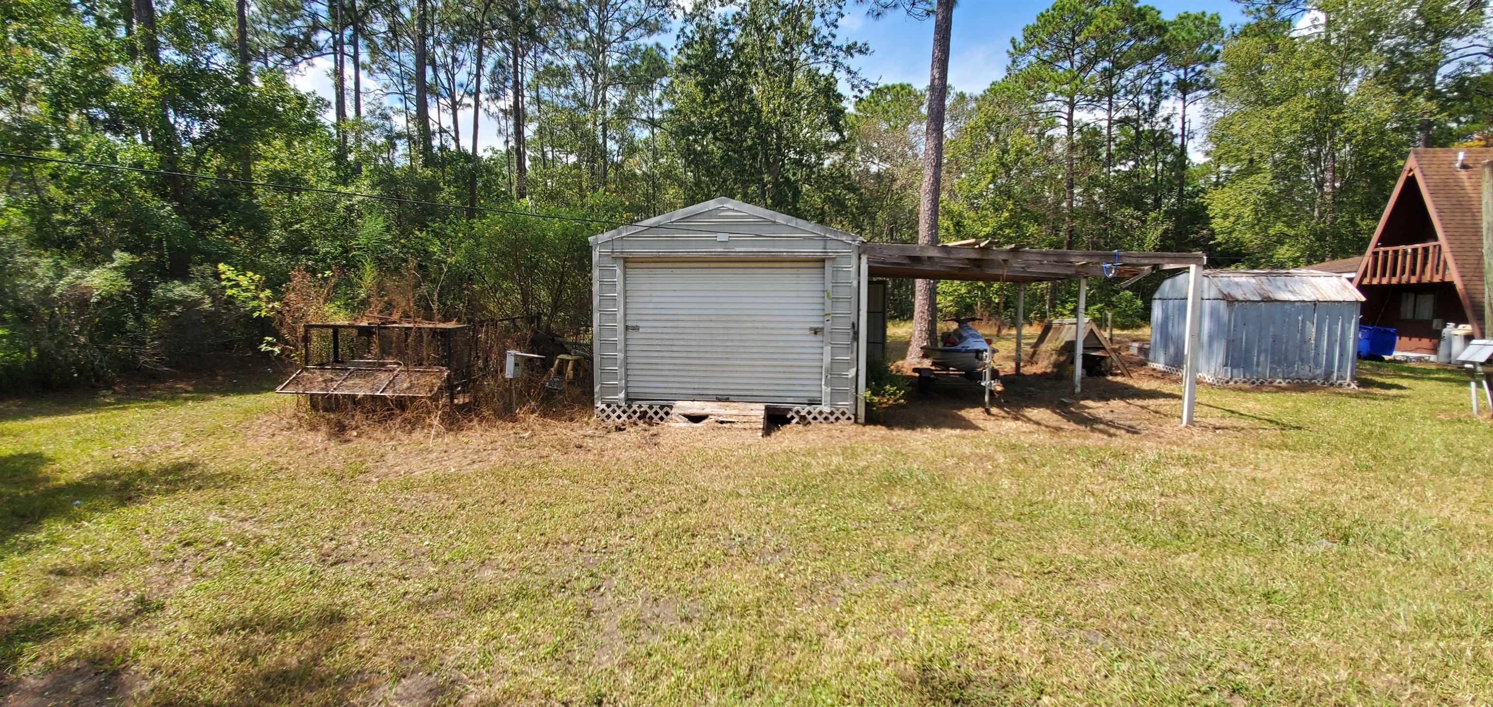3121 Green Acres Road St. Augustine, FL 32084 - Photo 32 of 35 a backyard of a house with yard and wooden fence