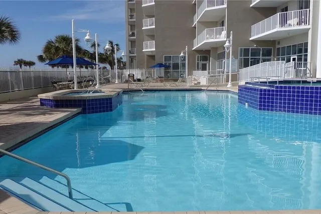a view of a swimming pool with a lounge chairs