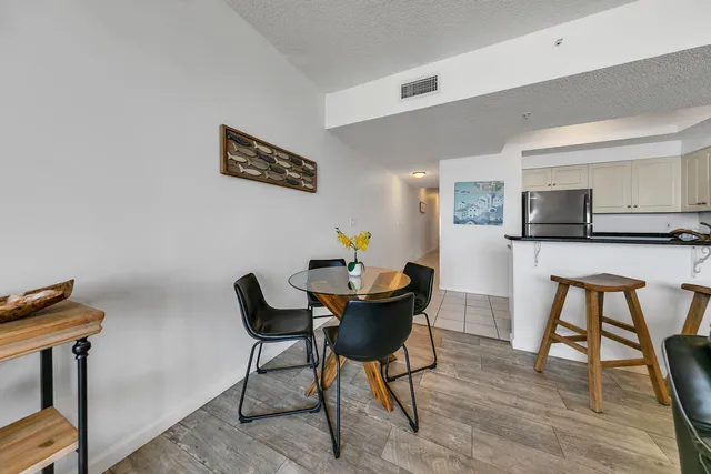 a dining room with furniture and wooden floor