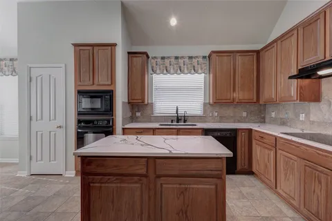 a kitchen with a sink stove and microwave