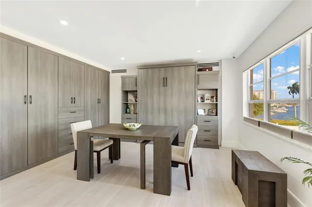 a view of a a dining room with furniture window and wooden floor