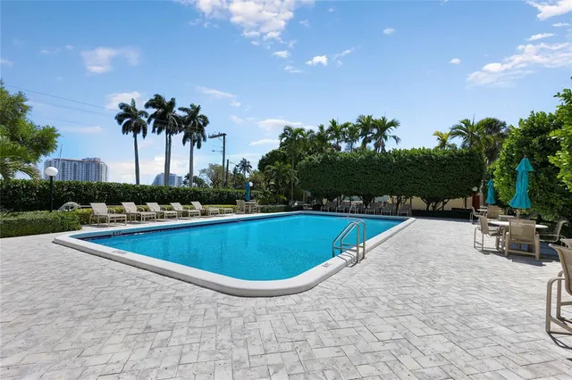 a view of a swimming pool and trees in the background