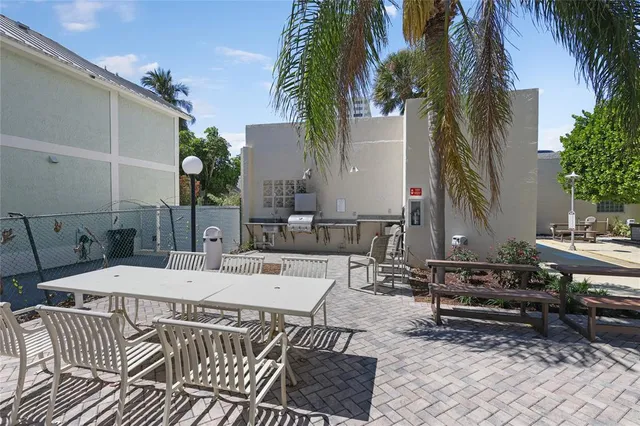 a view of a patio with a table and chairs and potted plants